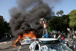 Waymo vehicles set on fire in downtown L.A, as protesters, police clash