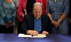 Colorado increases penalties for wage theft under bill signed by Gov. Jared Polis